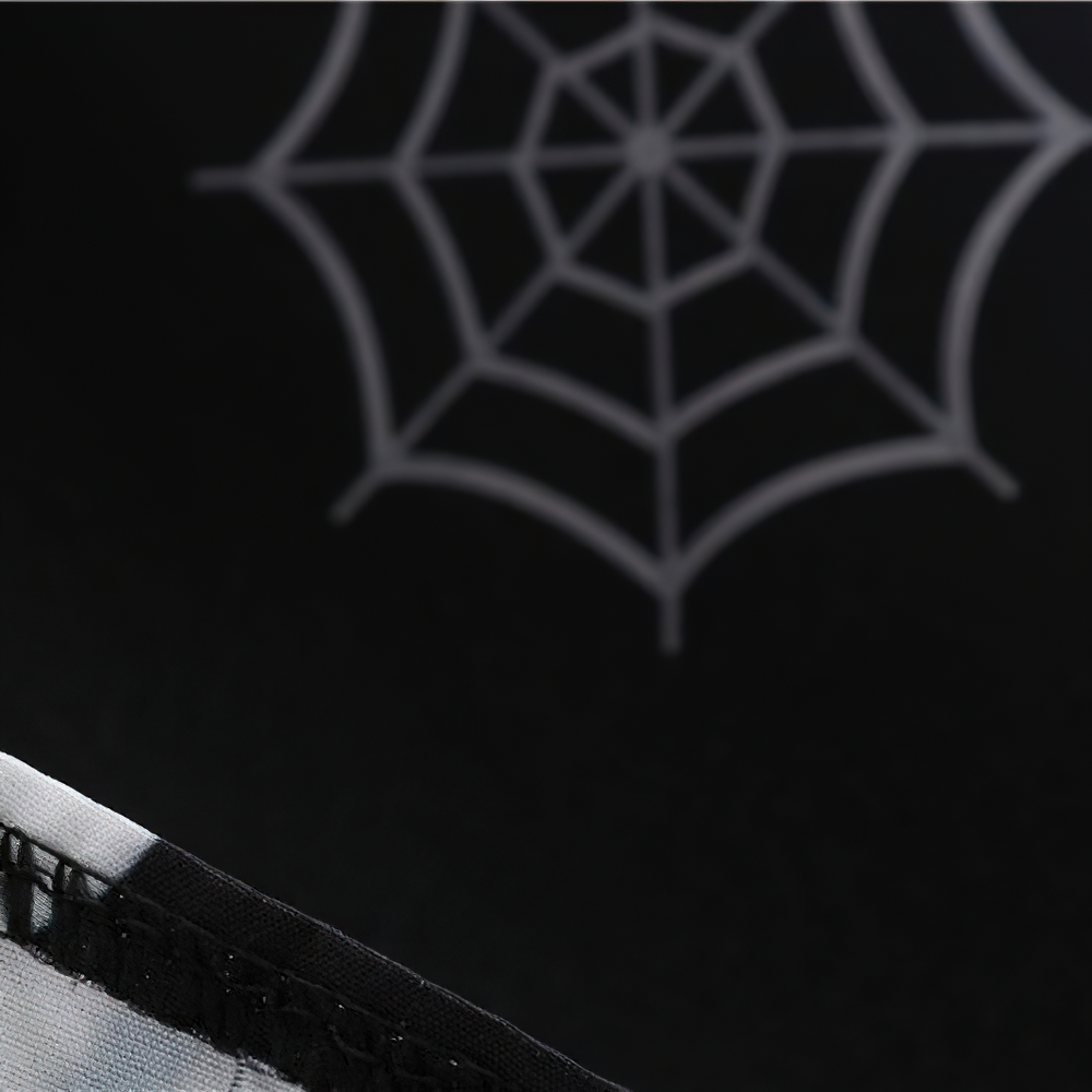 Close-up of a Halloween-themed fabric with a spider web print, perfect for spooky season decorations or clothing.
