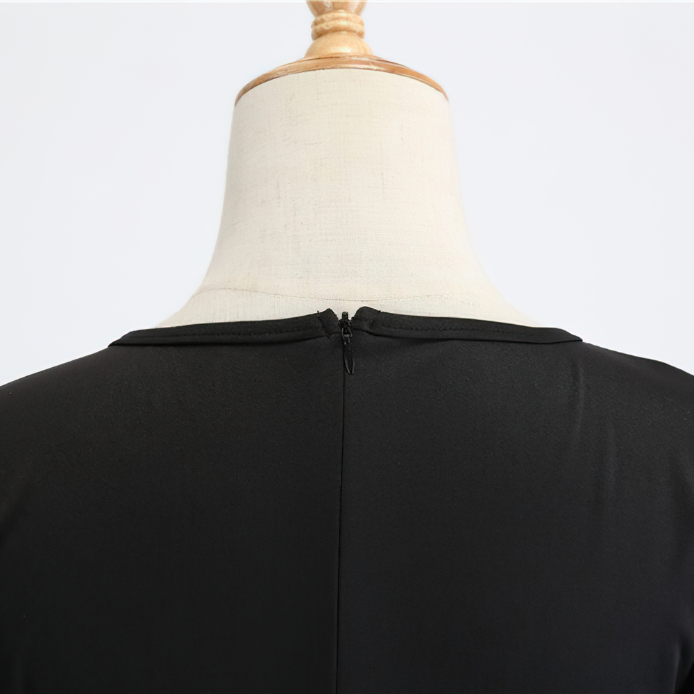 Back view of elegant women's Halloween dress showcasing zipper detail and black fabric.