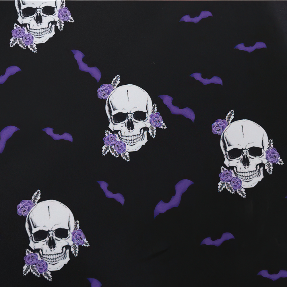 Black Halloween fabric featuring purple bats and skulls adorned with roses for a spooky chic design.