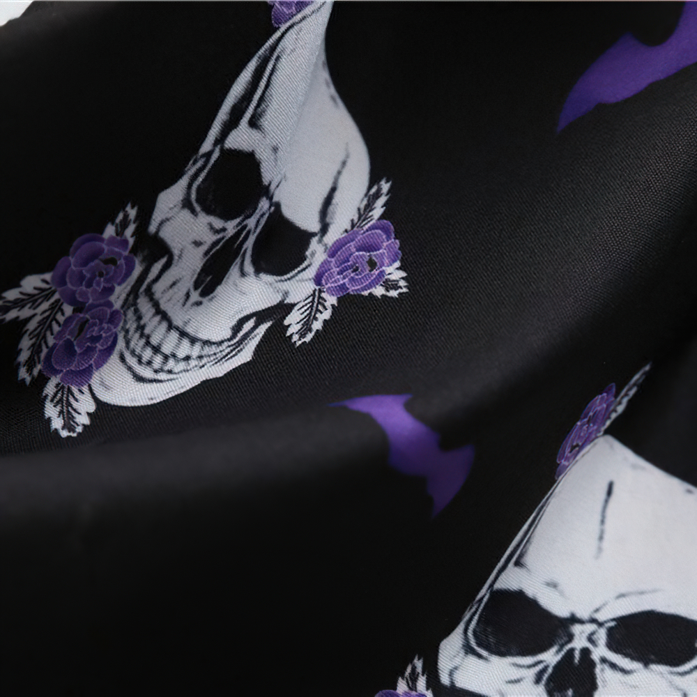 Close-up of black fabric featuring a skull and floral design, perfect for Halloween-themed apparel.