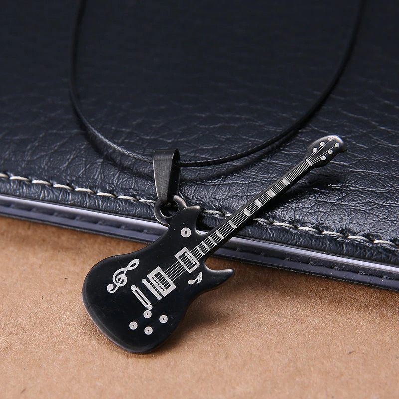 Black 316L stainless steel guitar necklace pendant resting on leather, perfect casual jewelry for music lovers.
