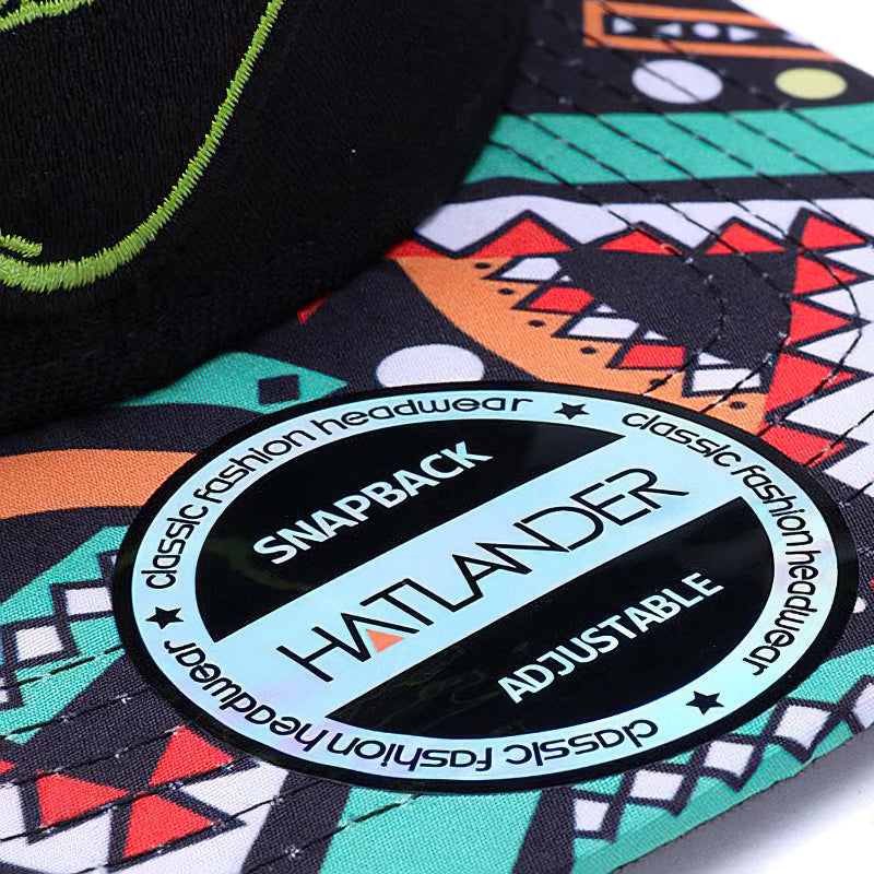 Fashion alternative style cap with adjustable snapback, featuring colorful retro patterns and a bold logo.