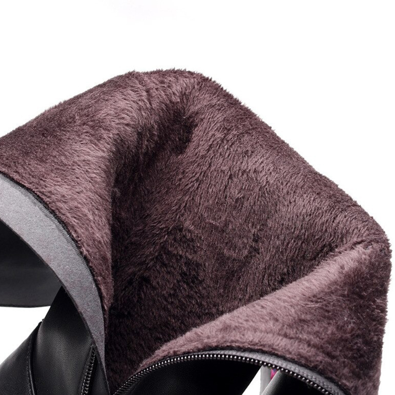 Close-up of soft fur lining inside women's black PU leather boots, adding warmth and comfort for stylish wear.