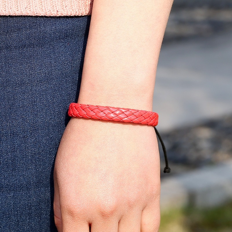 Handmade red braided leather bracelet worn on wrist, perfect for punk style fashion.