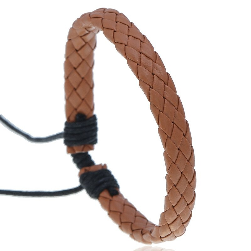 Fashion braided leather bracelet in punk style, handmade accessory in warm brown tones.