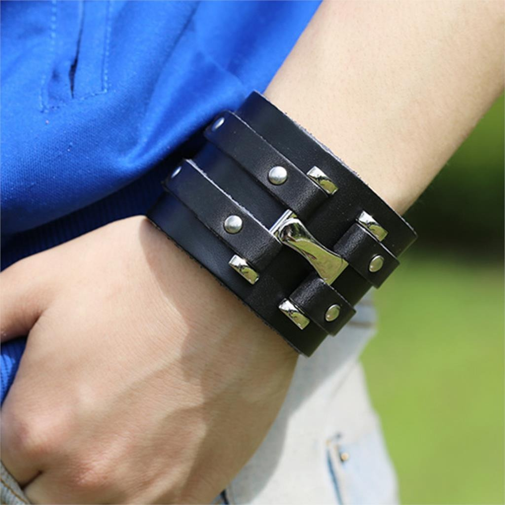 Fashion braided wrap leather bracelet in punk rock style with silver fittings on wrist, perfect accessory for edgy outfits.