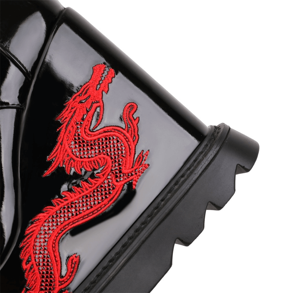 Close-up of stylish black boots featuring eye-catching red dragon embroidery on the side, perfect for gothic fashion.