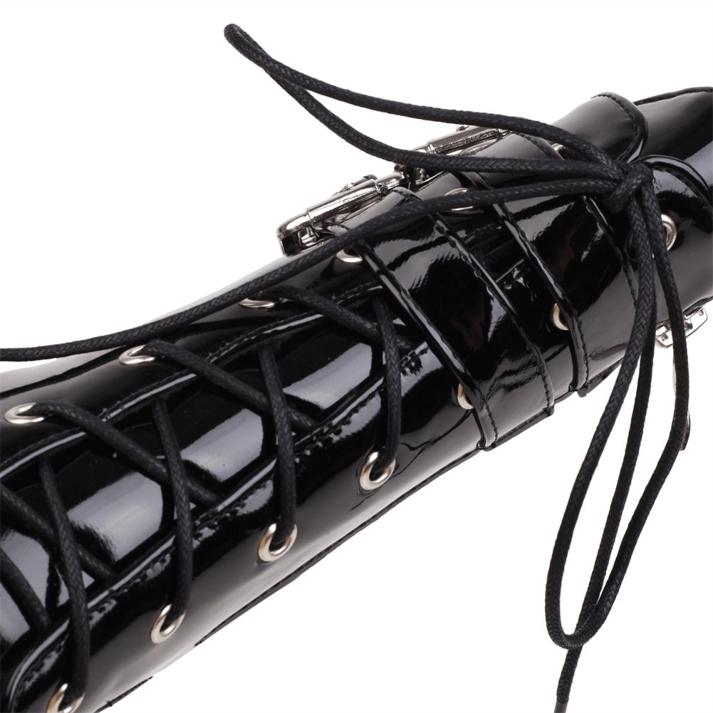 Close-up of black high heel boots with intricate lace-up design and shiny patent finish, ideal gothic footwear.