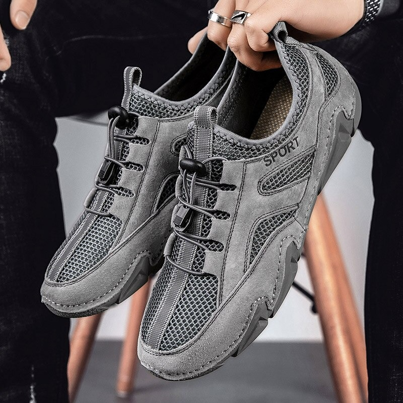 Stylish men's casual leather shoes with mesh inserts for breathability, perfect for a sporty look.
