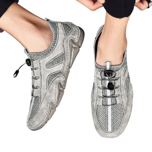 Men's casual leather sneakers with mesh inserts for breathability in grey color.