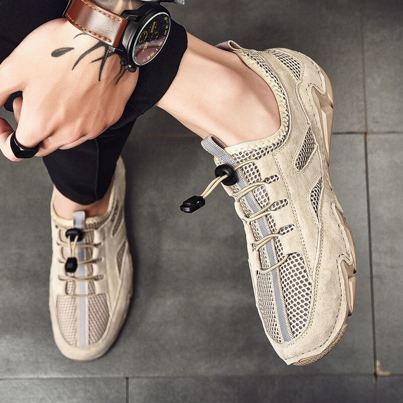 Men's casual leather sneakers with mesh inserts, stylish and breathable for all-day comfort.