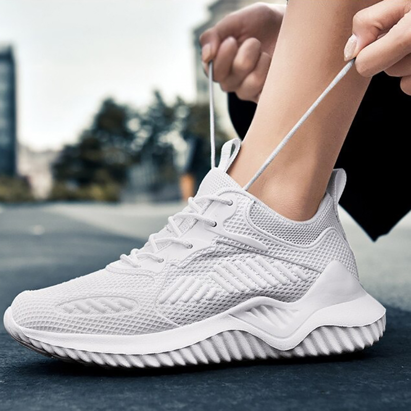 Breathable white mesh sneakers for sports, featuring a flexible sole and stylish design, perfect for casual wear.