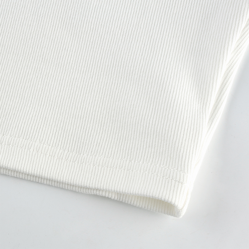 Detail of a women's white tank top showcasing the quality knit fabric and trendy sleeveless design.