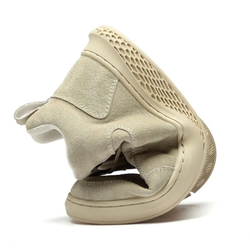 Side view of stylish cream suede boots with a flexible rubber sole for men, perfect for casual wear.