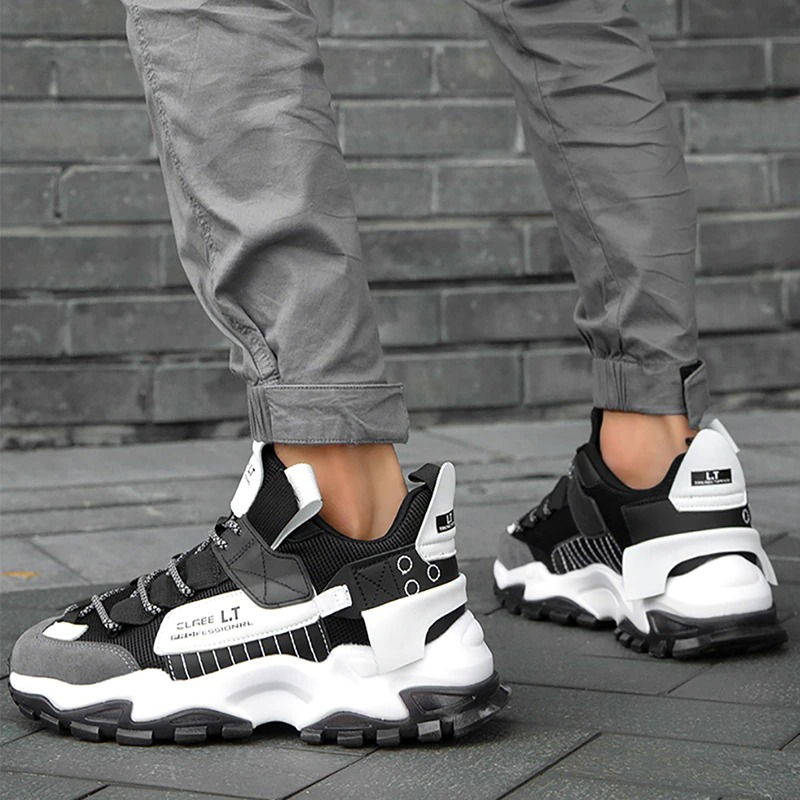 Men's breathable black and white sneakers with flexible sole, perfect for casual and sport activities.