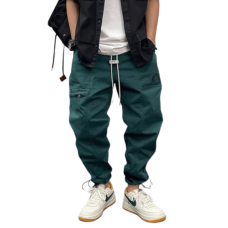 Casual drawstring harem cargo pants in teal, styled with white sneakers and a black shirt, perfect for everyday wear.