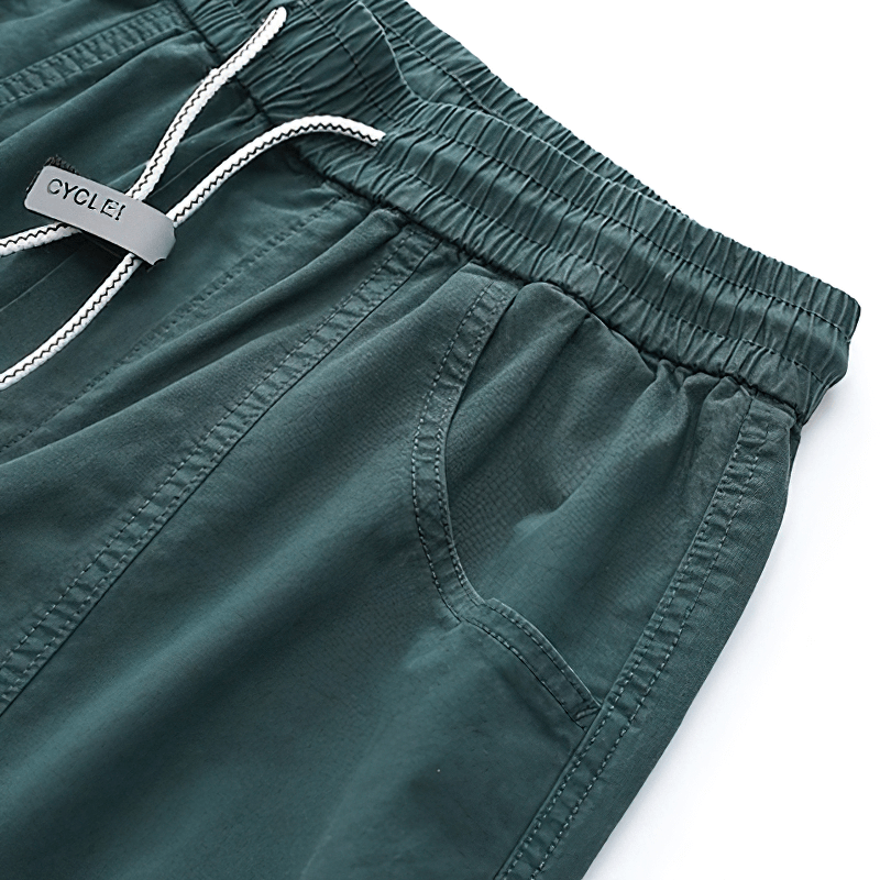 Casual harem pants in deep green featuring a drawstring waist and side pockets for comfort and style.