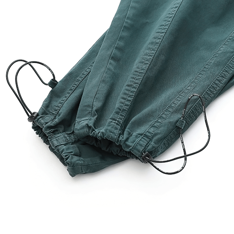 Close-up of the drawstring and elastic cuffs on casual harem cargo pants in a stylish teal color.