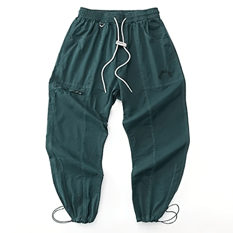 Fashion drawstring harem pants in teal, featuring a casual elastic waist and multiple pockets for style and comfort.