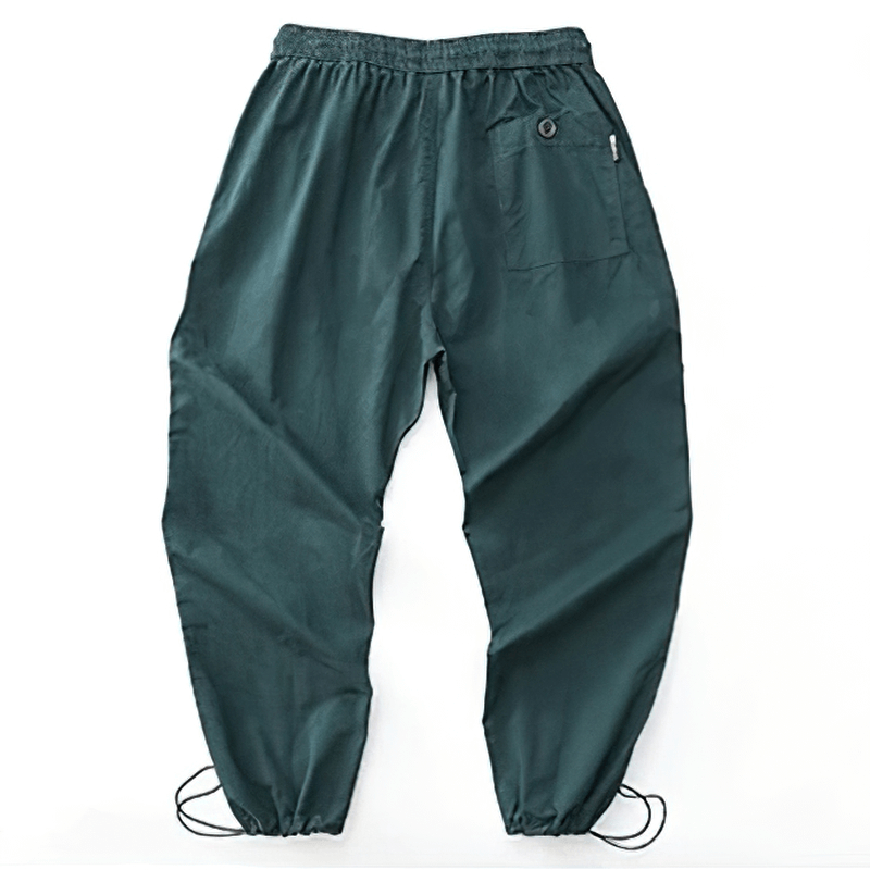 Casual drawstring harem pants in deep green, featuring elastic waist and cargo style, perfect for a modern wardrobe.