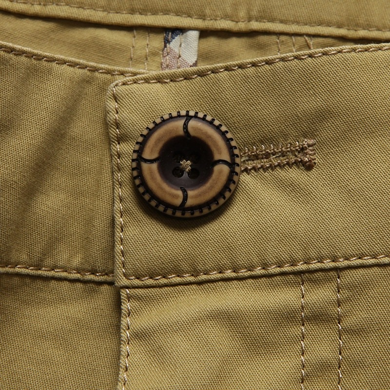 Close-up of a stylish button on men's cotton cargo shorts, showcasing quality craftsmanship and attention to detail.