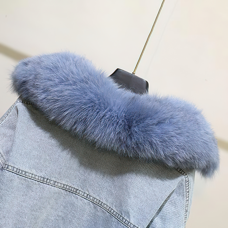 Close-up of a stylish denim parka with soft blue faux fur collar, perfect for winter warmth and casual fashion.