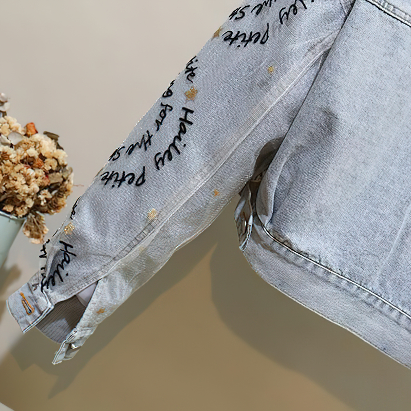 Casual women's denim parka jacket featuring beaded embroidery and stylish inscriptions on sleeves.