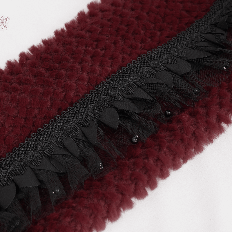 Close-up of a fashion faux fur scarf, featuring a red plush fabric with black lace and beading for a gothic touch.