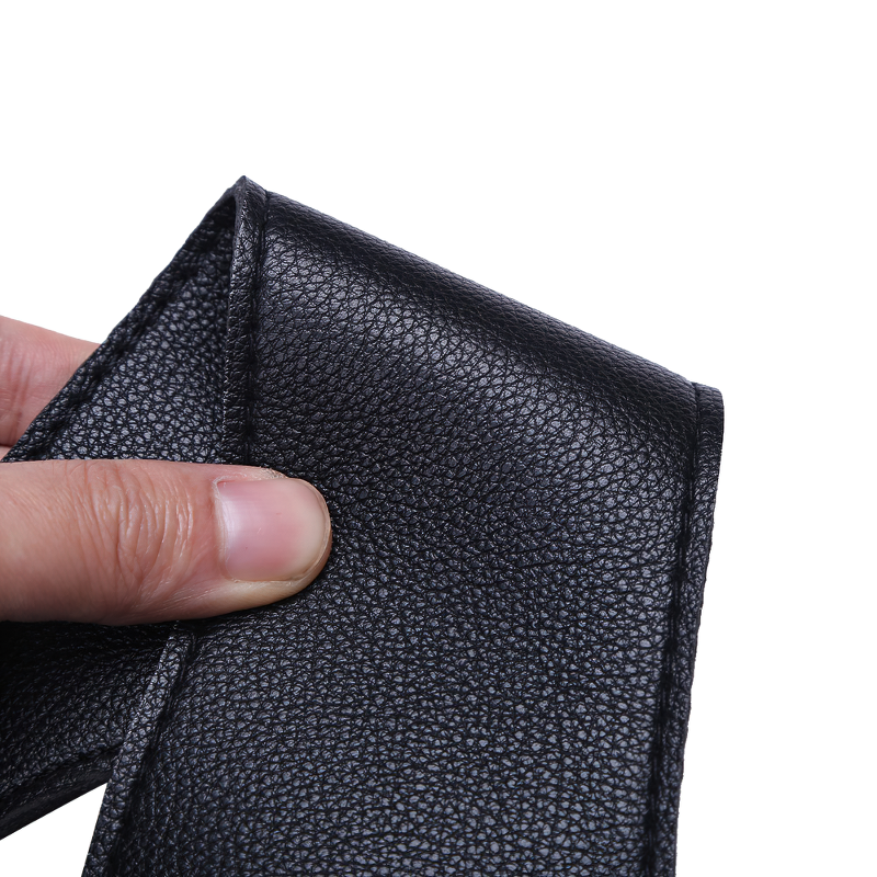Close-up of black faux leather texture showing detail of cosplay chest harness accessory.