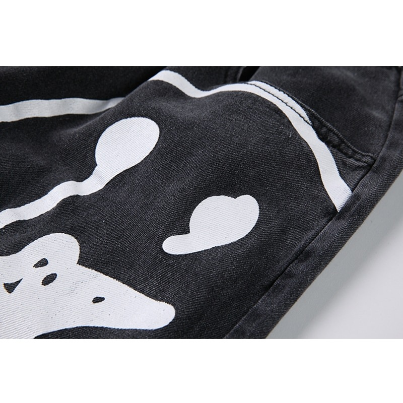 Close-up of black denim fabric featuring playful ghost print, perfect for casual women's fashion.
