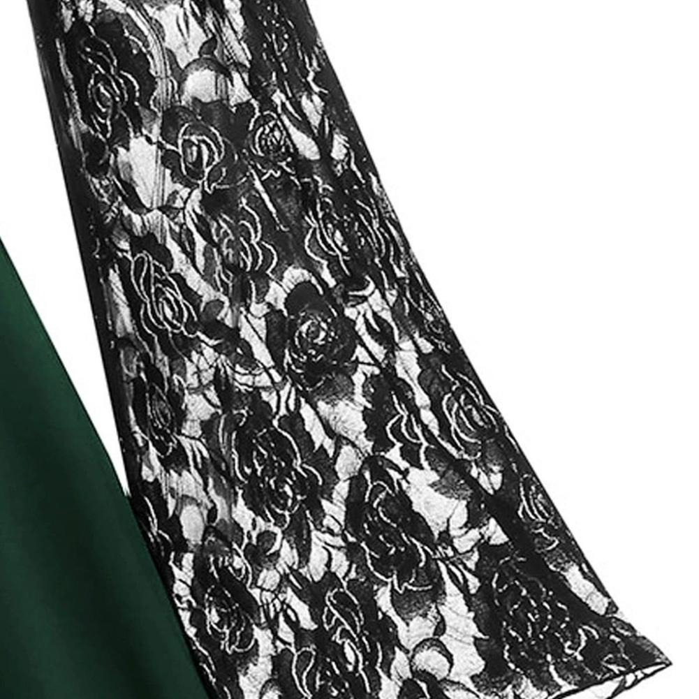 Close-up of gothic women's dress flare sleeve featuring intricate black lace patchwork with floral design.