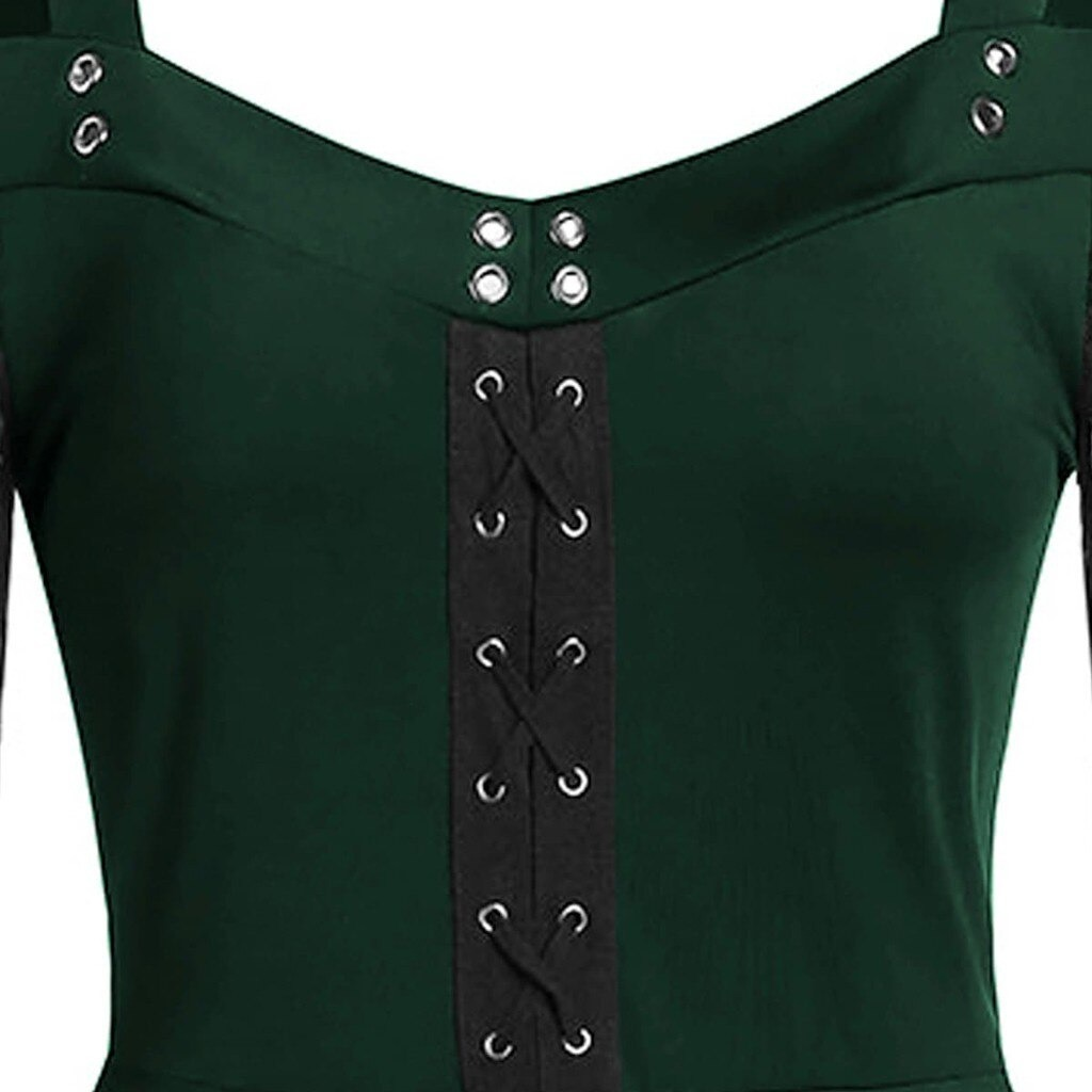 Close-up of Gothic women's lace patchwork dress with green fabric and silver button detail.