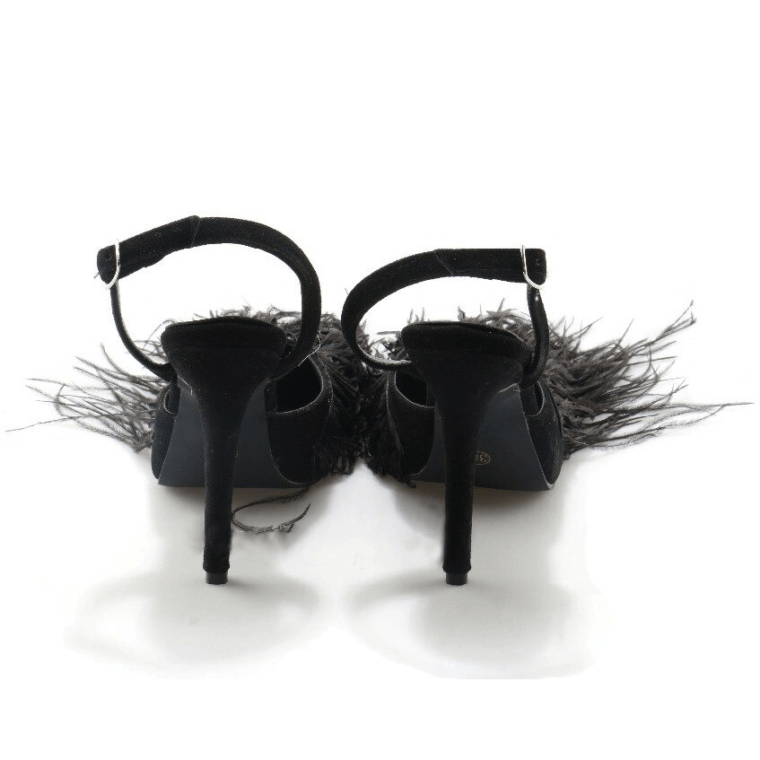 Back view of vintage black flock women's shoes with fringes and pointed toe design.