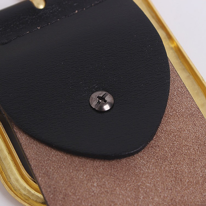 Close-up of black and tan leather detail showcasing metal buckle on a stylish wide corset belt for women.