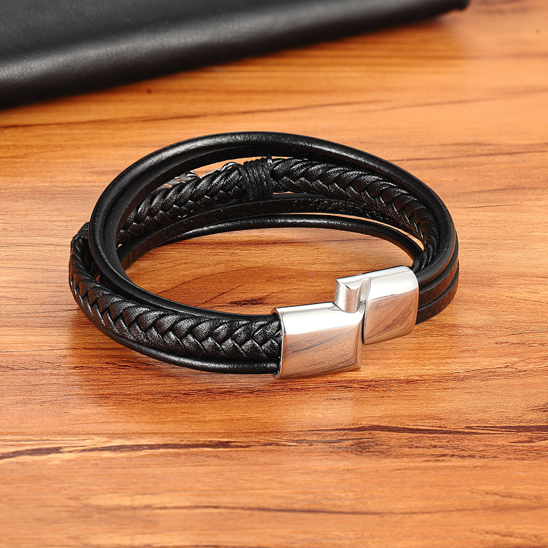 Trendy braided black leather bracelet with stainless steel clasp, stylish accessory for men and women.