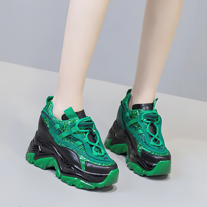 Green and black chunky platform sneakers with lace-up design and unique shiny details, perfect for casual outfits.