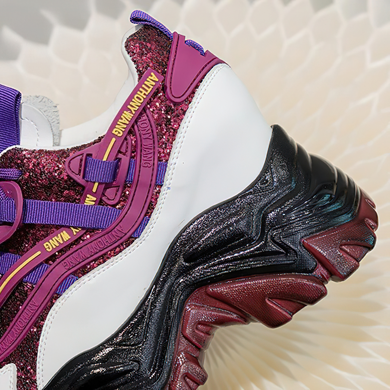 Close-up of colorful chunky platform sneakers with glittery design and lace-up details for women's casual fashion.