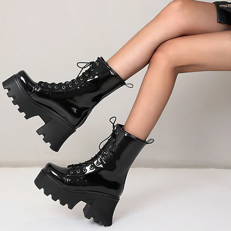 Stylish women's black patent leather platform boots with lace-up design and chunky tractor soles.