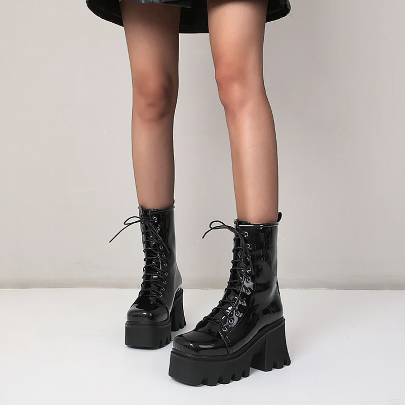Fashionable women's genuine leather platform boots in black, featuring a round toe and lace-up design.