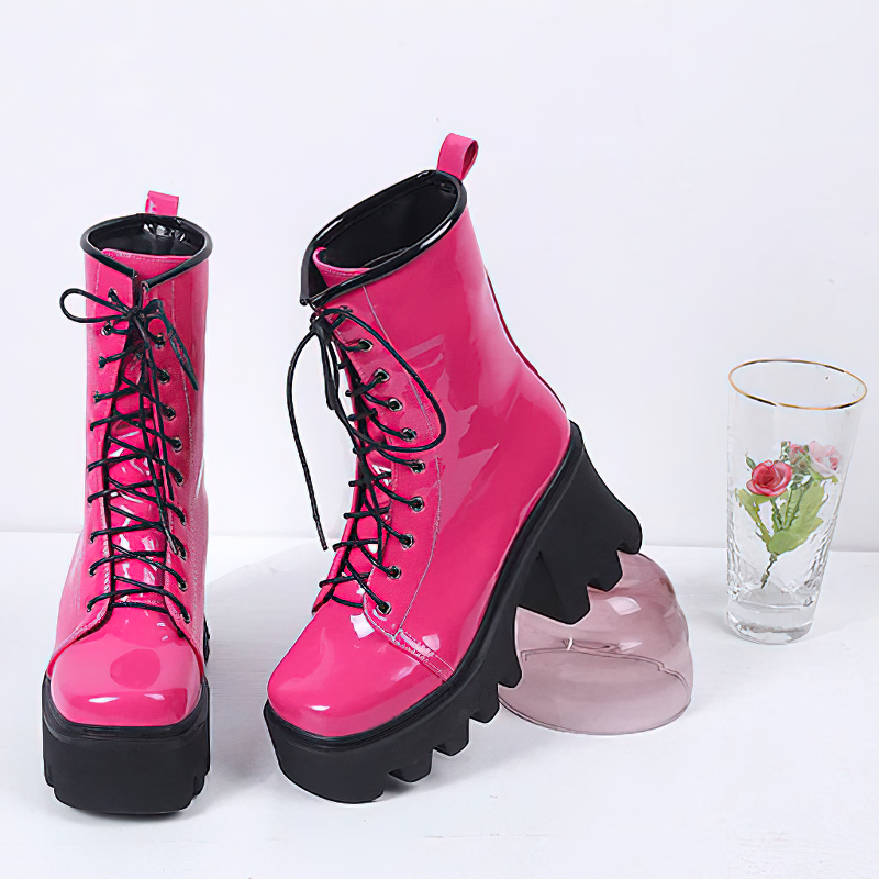 Stylish women's pink patent leather platform lace-up ankle boots with a chunky tractor sole.