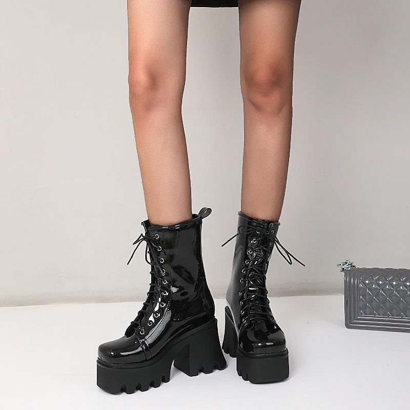Women's black genuine leather platform ankle boots with round toe and lace-up design, perfect for casual wear.