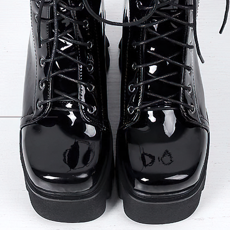 Stylish black genuine leather platform ankle boots with round toe and lace-up design, perfect for a casual look.