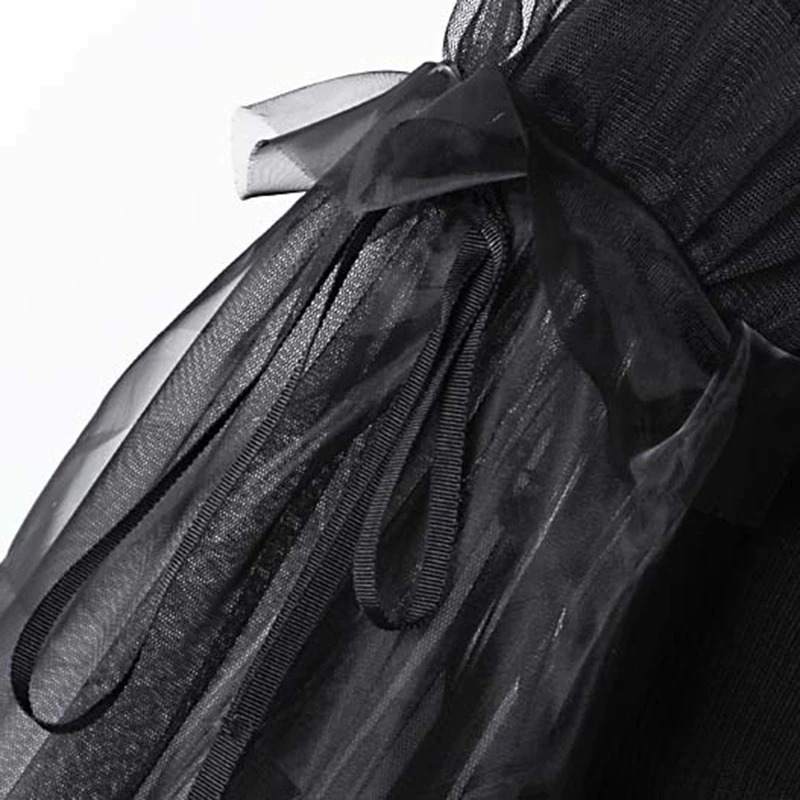 Close-up of the elegant black tulle ribbon detail on a gothic style turtleneck sweater for women.
