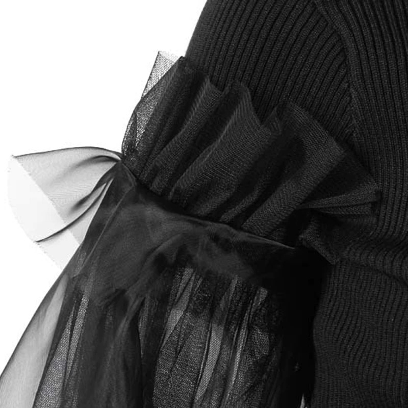 Close-up of black Gothic turtleneck dress sleeve featuring stylish sheer tulle ruffles for a dramatic look.
