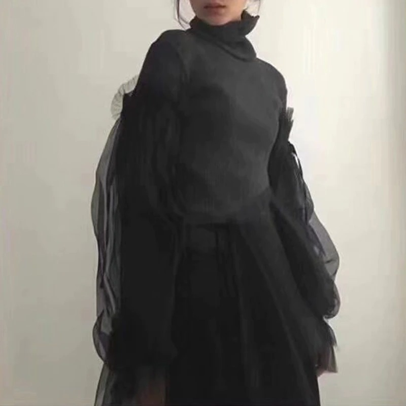 Black women's gothic turtleneck sweater with long sheer sleeves, perfect for alternative fashion and stylish performances.