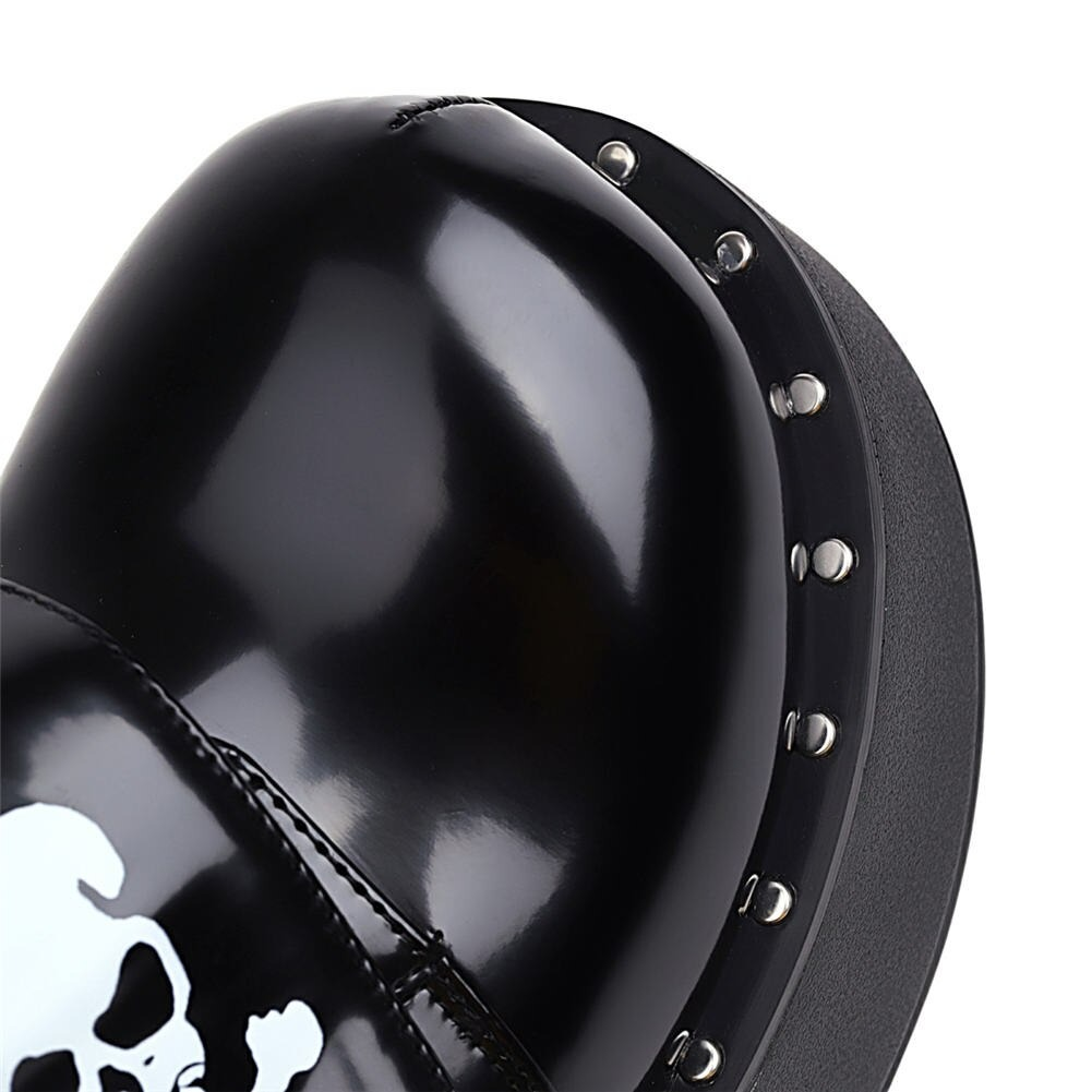 Close-up of women's gothic platform shoes featuring a sleek patent finish and skull design.