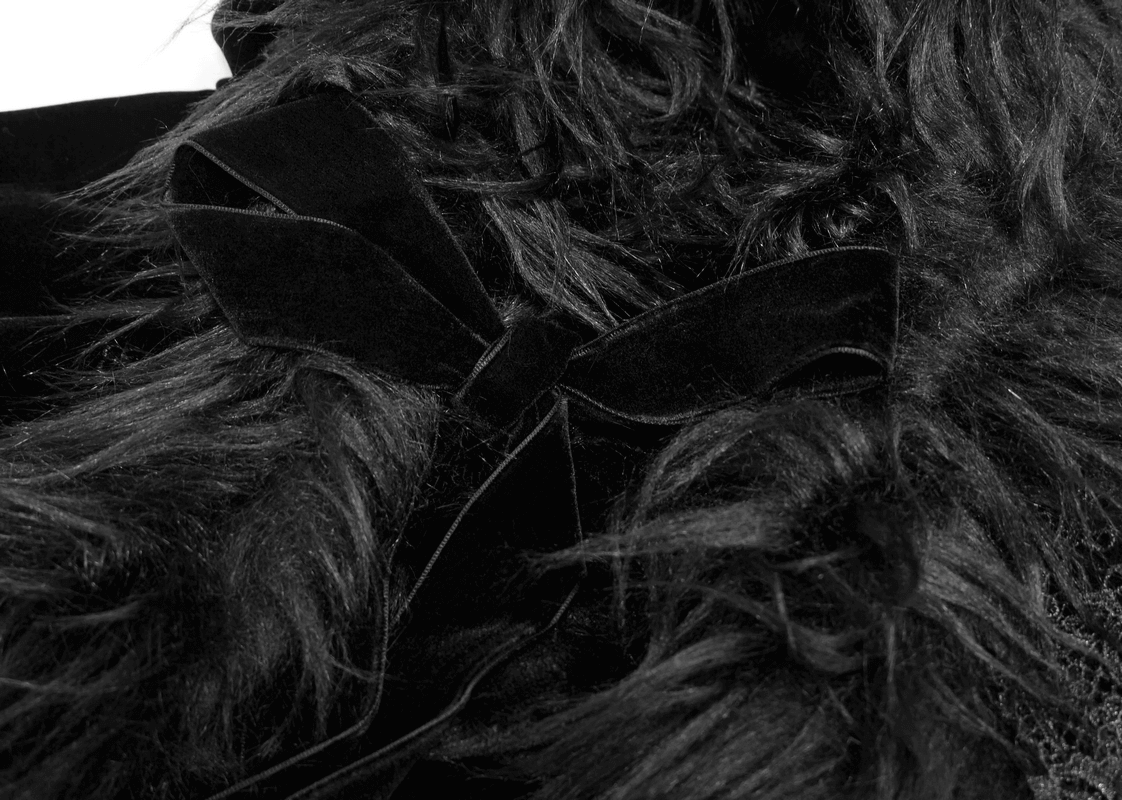 Close-up of the fur inserts and bow detailing on a women's gothic black velvet cloak.