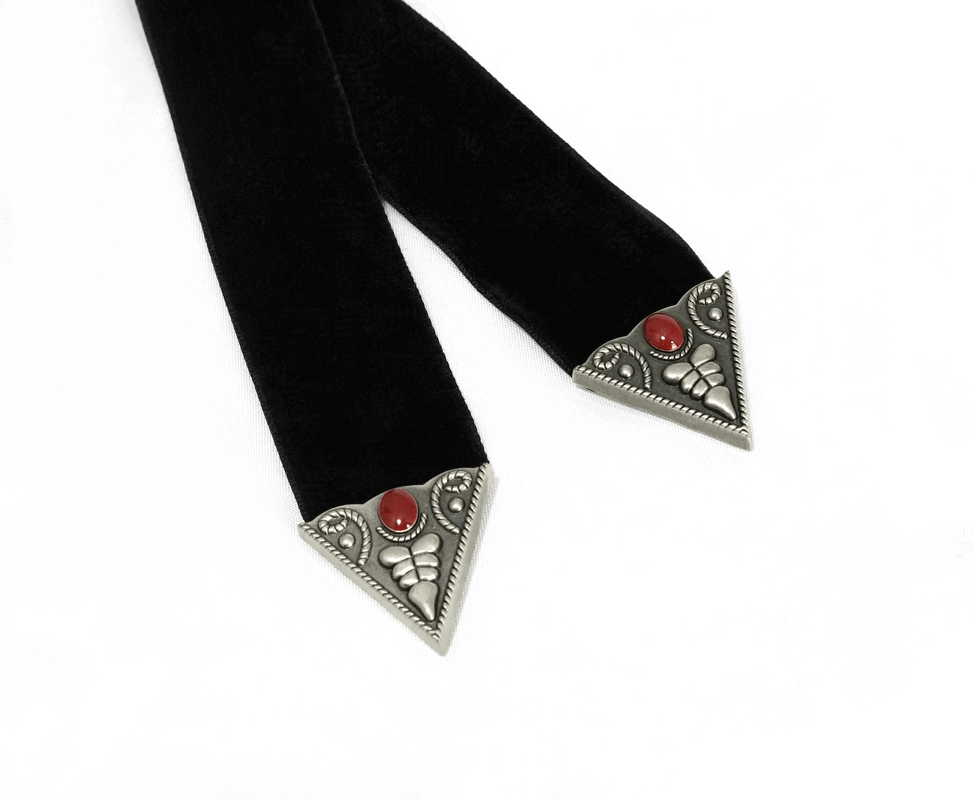 Gothic velvet choker with silver triangular ends and red decorative stones.