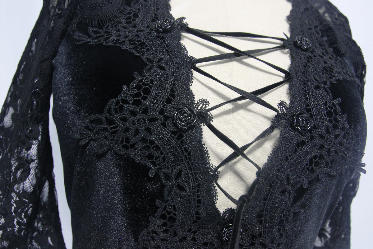Close-up of a black gothic mini dress featuring lace details and a stylish crisscross design.