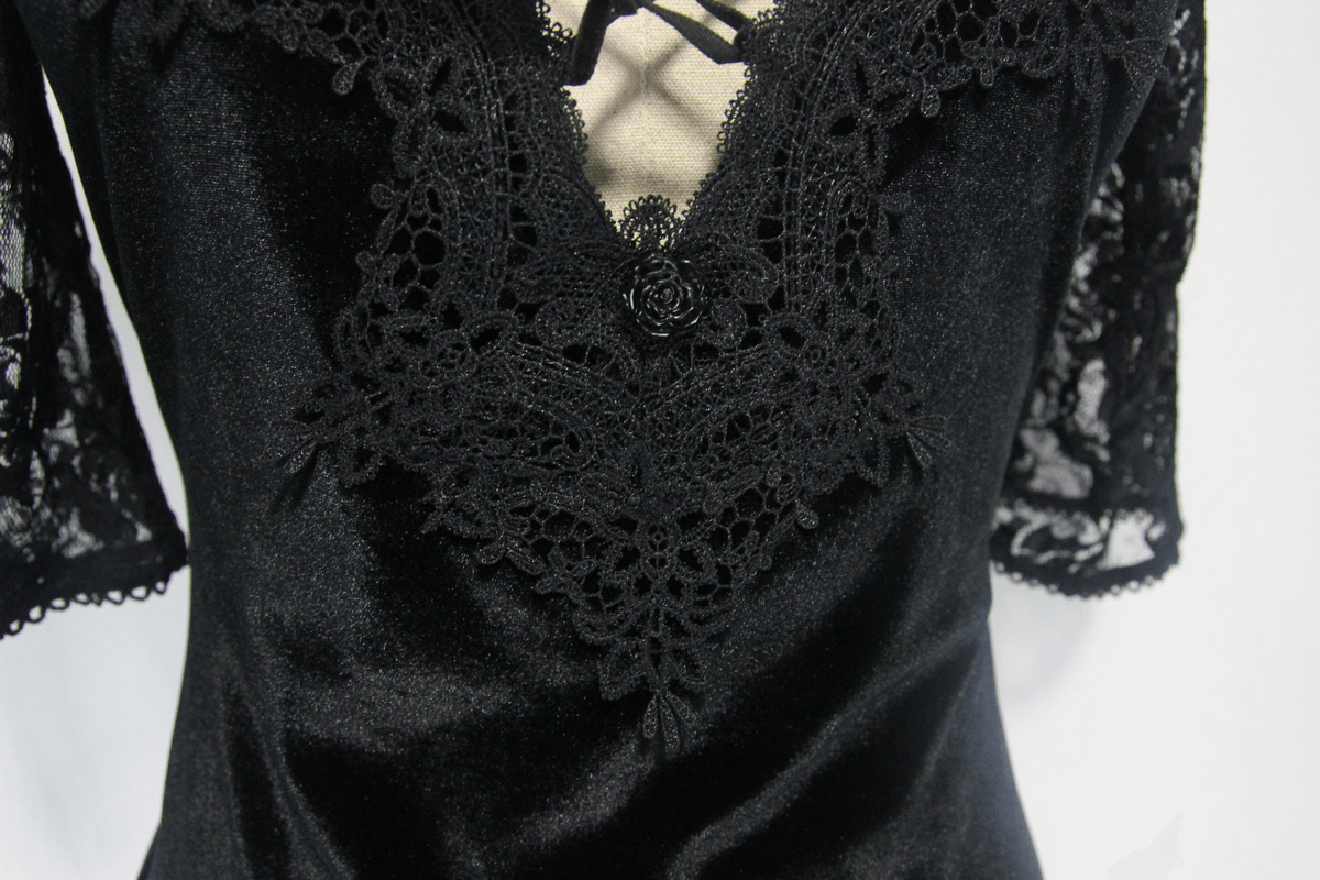 Close-up of elegant black lace mini dress with gothic floral detailing and short sleeves, perfect for alternative women's fashion.